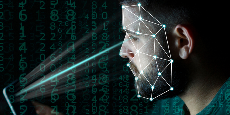 Man looking at his mobile phone. The man's face is being analyzed by the mobile phone through emotional AI to read his facial cues and create personalized digital marketing ads based on what he reacts to.  