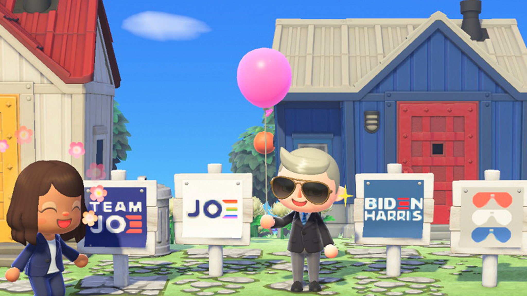 Les avatars de Joe Biden et de Kamala Harris dans le jeu vidéo "Animal Crossing New Horizons" sont devant des maisons et des panneaux affichant les logos de la campagne Biden/Harris. Les avatars sont souriants. 