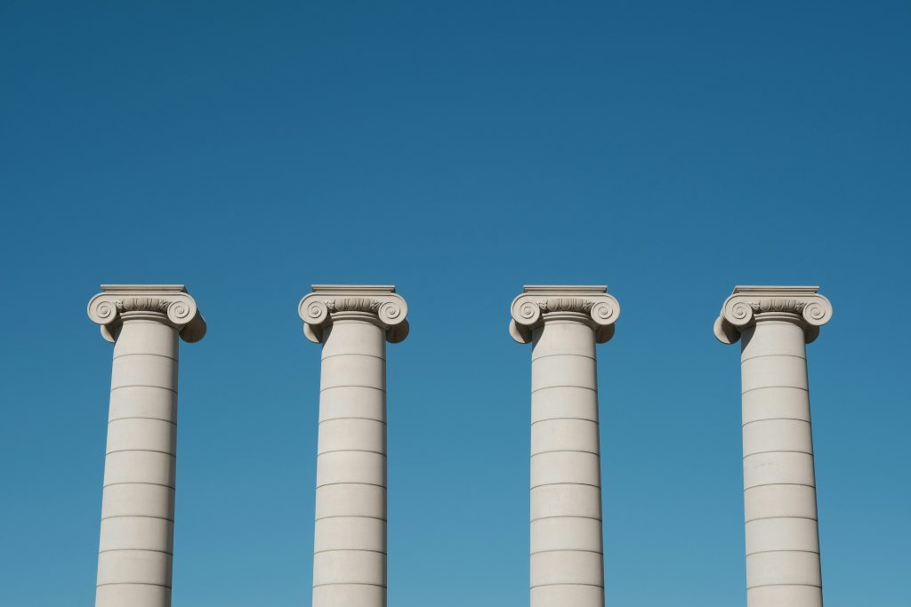 Ionic pillars on blue sky background.