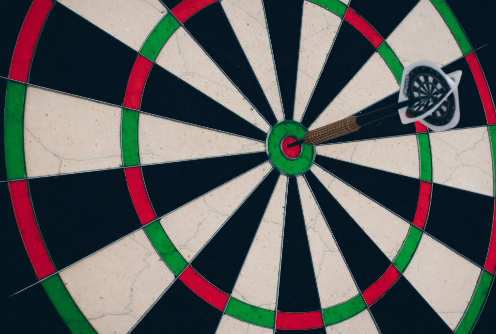Dart board with dart in the bullseye.