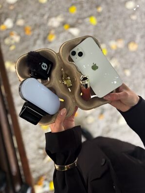 Hands holding a handling tray. There is a phone to illustrate the influencer marketing theme.
