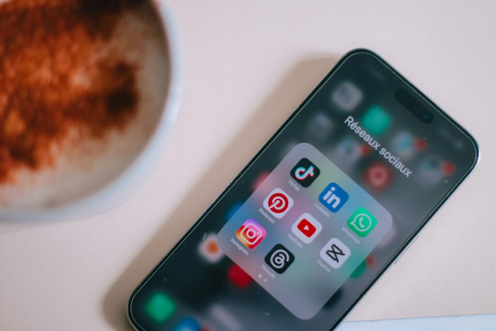 Phone sitting on a table, opened with the social media tab open. Source: https://unsplash.com/photos/a-close-up-of-a-cell-phone-on-a-table-yN5DVnKunmo